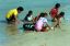 CLICK FOR FULLSIZE IMAGE Children play at the shoreline 