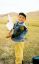 CLICK FOR FULLSIZE IMAGE Aanda helps his brother play 